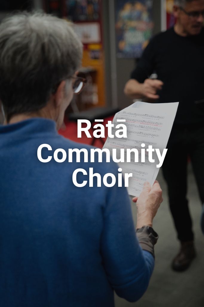 Woman reading sheet music. Text says Rata Community Choir. Click to learn more about this programme.