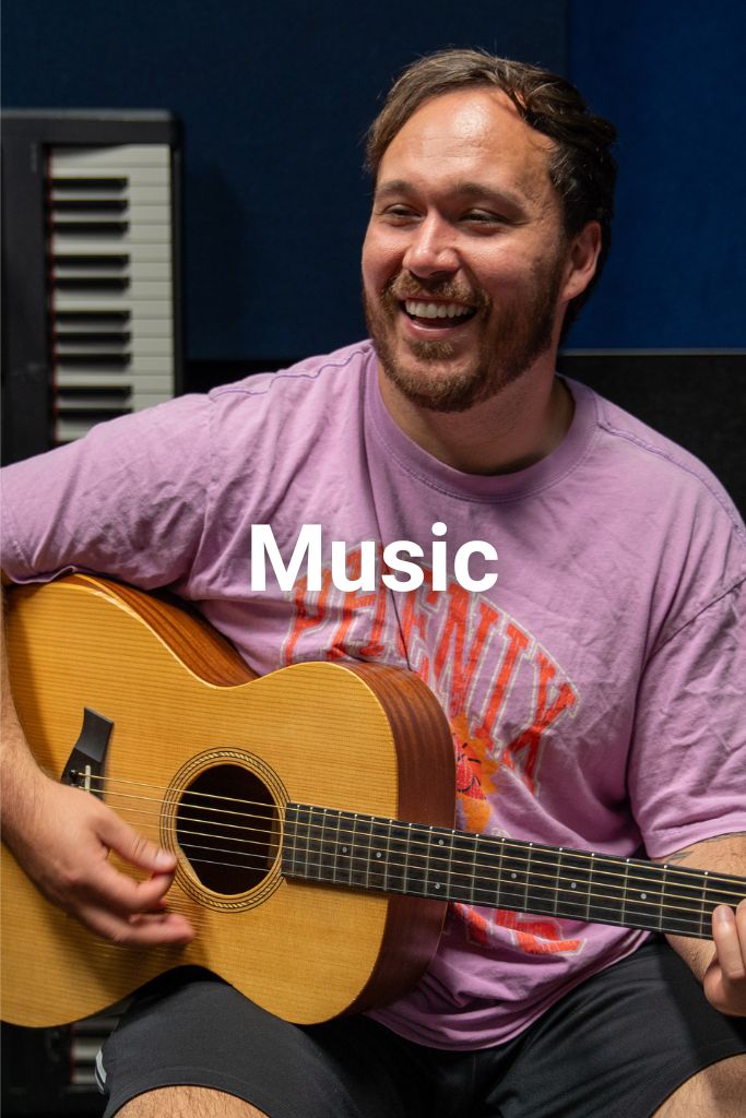 Man playing guitar at Rata Studios in Wellington. Text on image says Music. Click on this image to learn about our music programmes.
